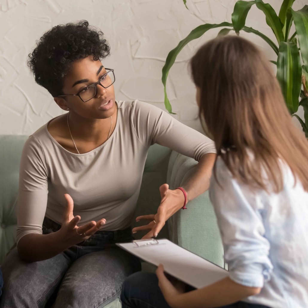 Unhappy african wife talking to psychologist complaining on bad relationship